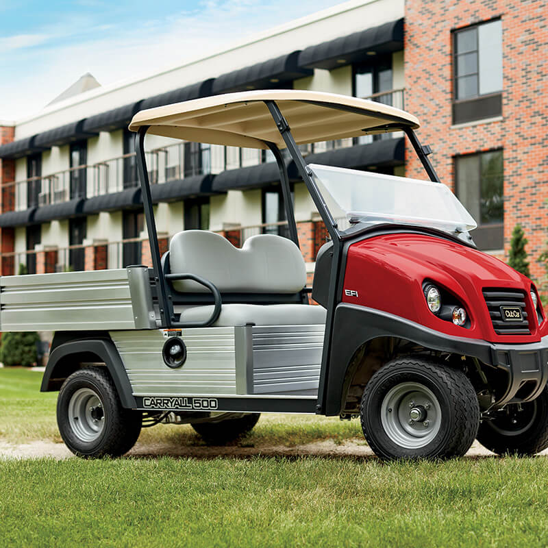 Red Carryall golf car parked in front of a building in Nassau, Bahamas